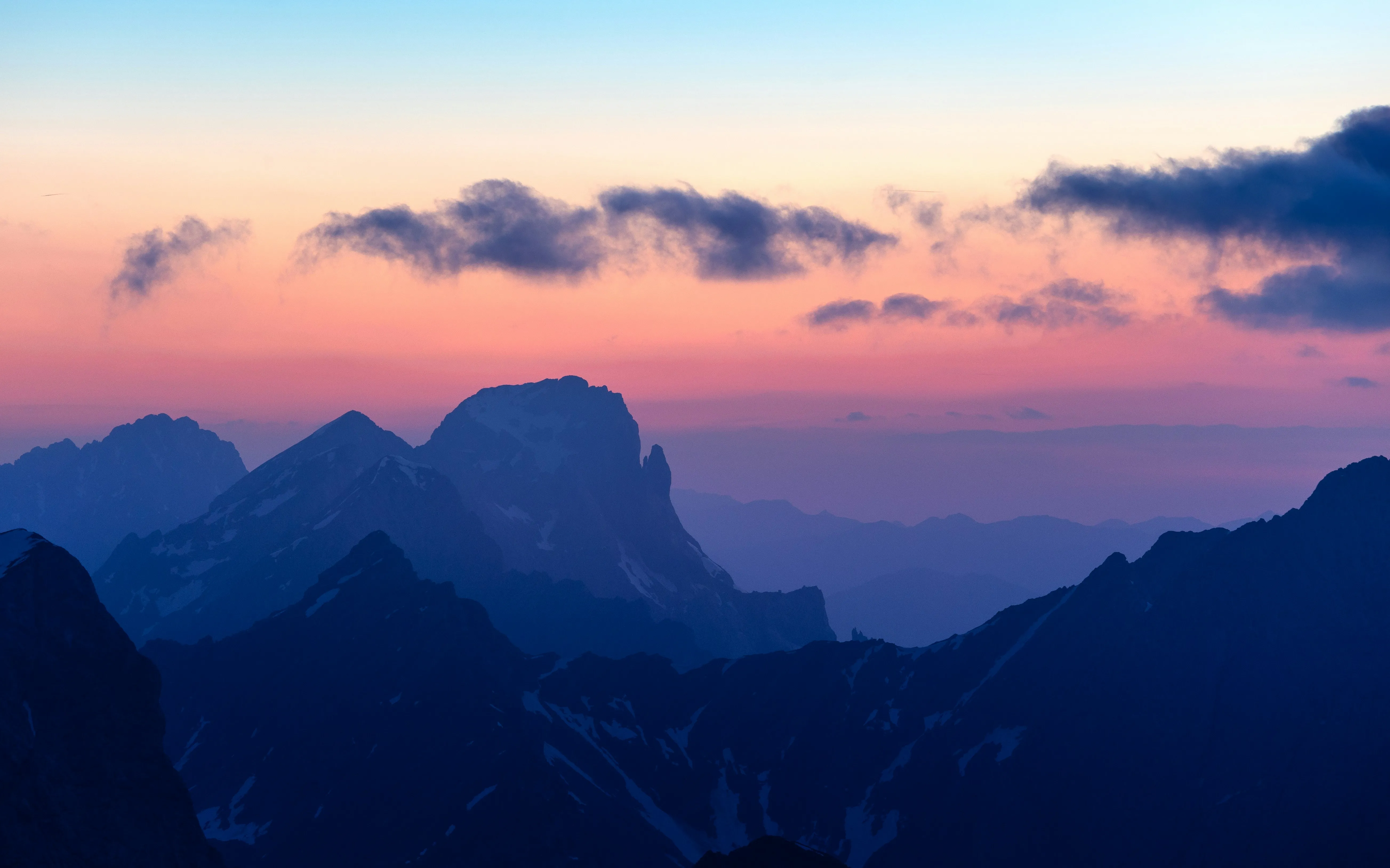 Dramatic Purple Sunset Over Distant Mountain Peaks