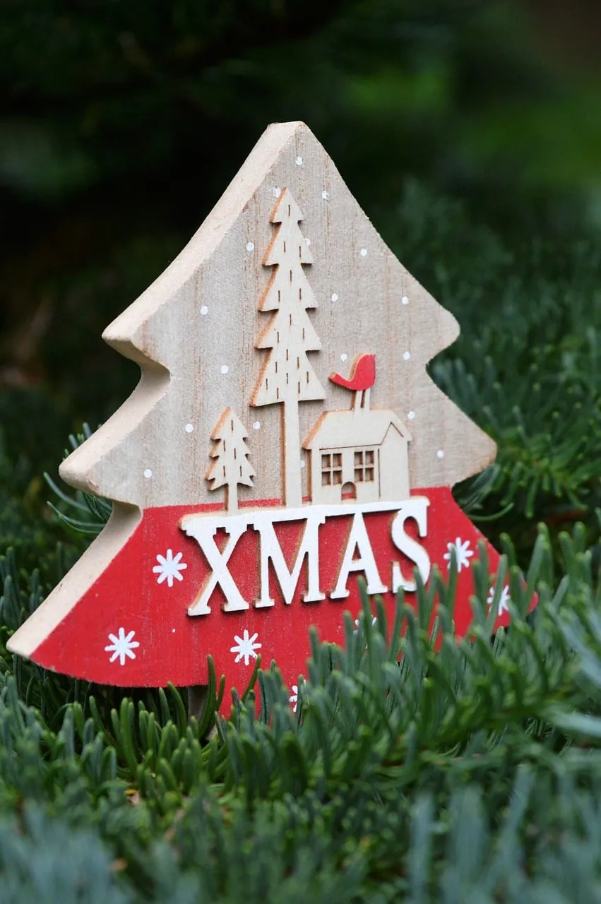Charming Wooden Xmas Decoration on Lush Greenery