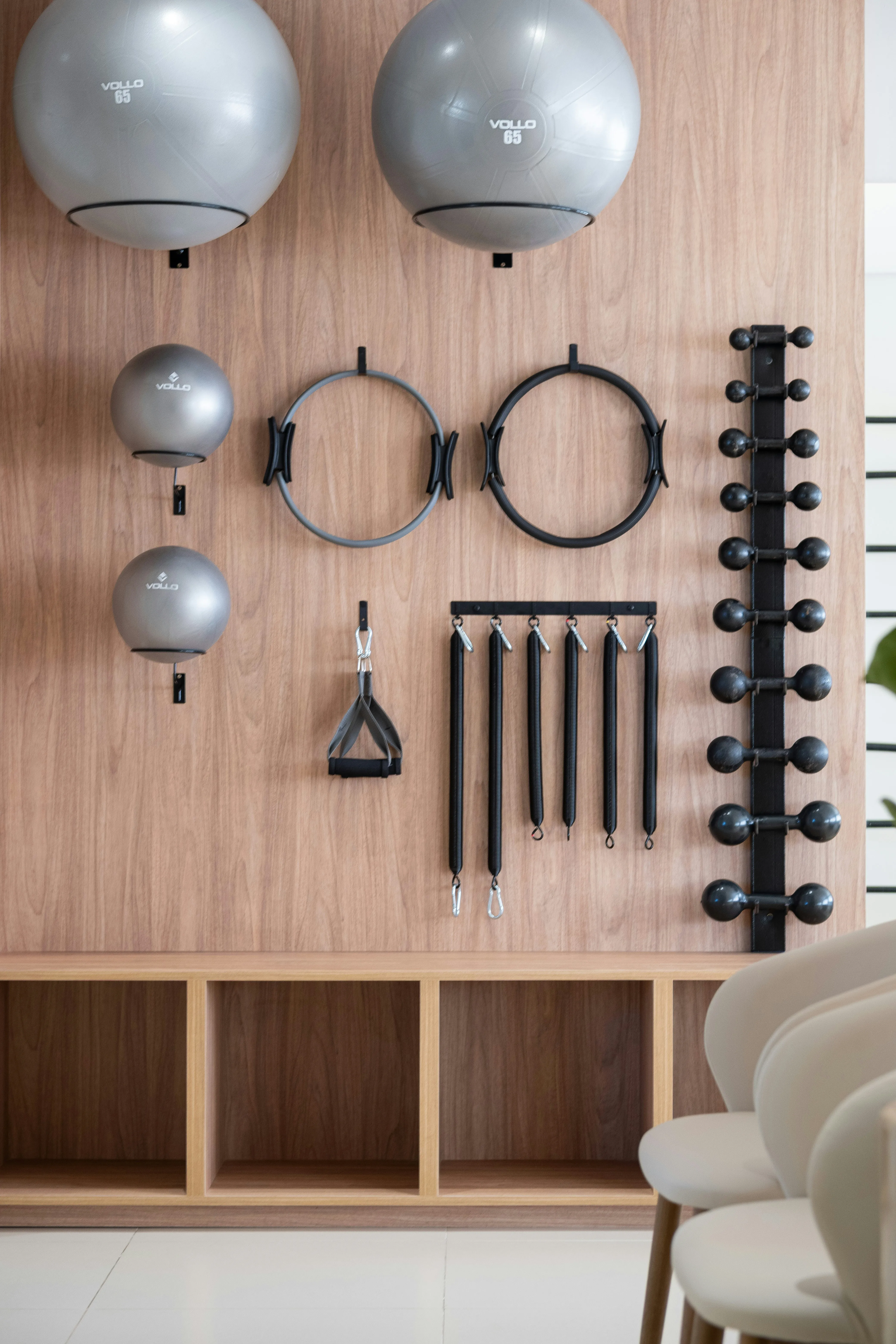 Zen Fitness: Organized Gym Equipment on a Stylish Wooden Wall