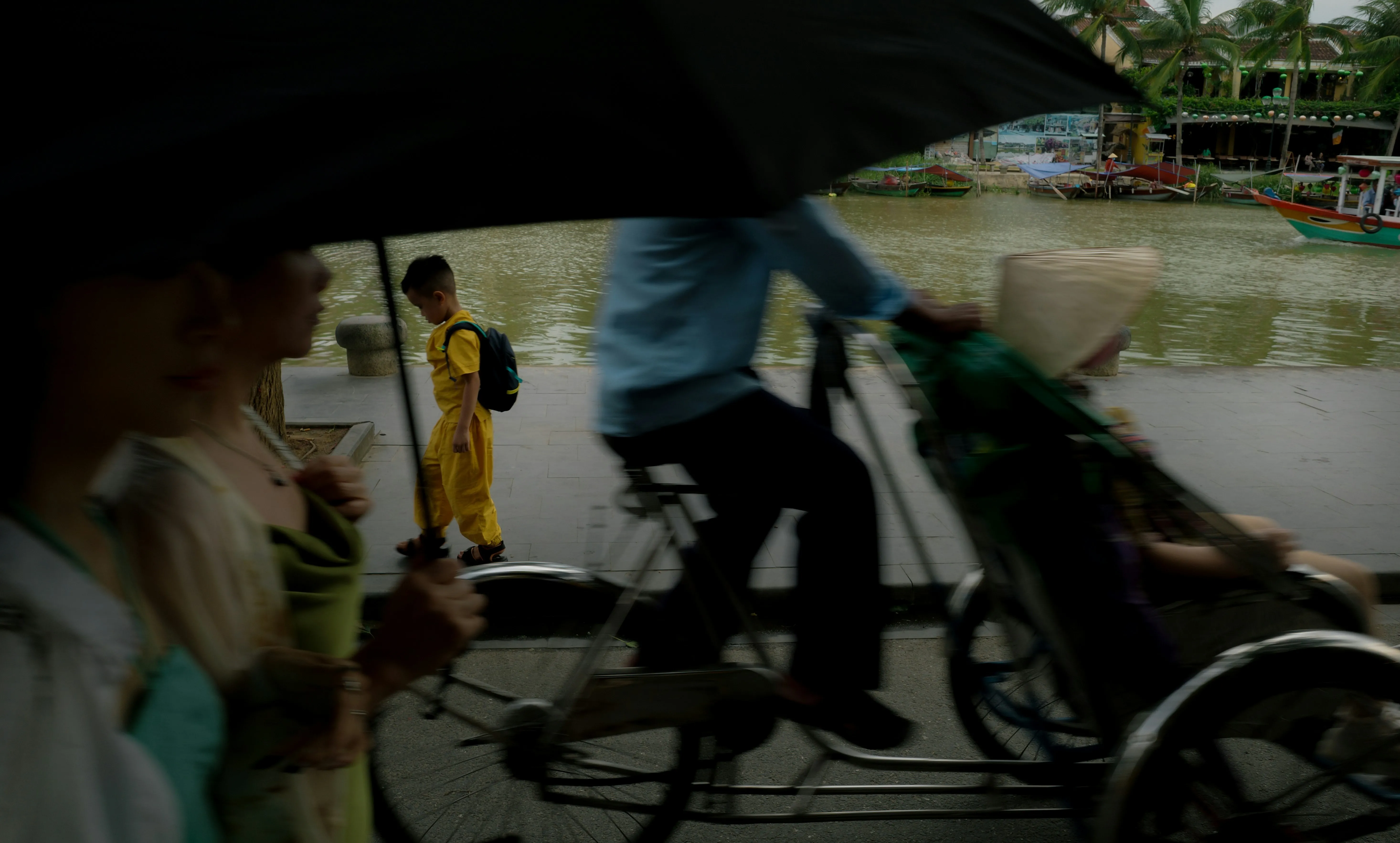 Vibrant Yellow Amidst Rainy Riverside Hustle