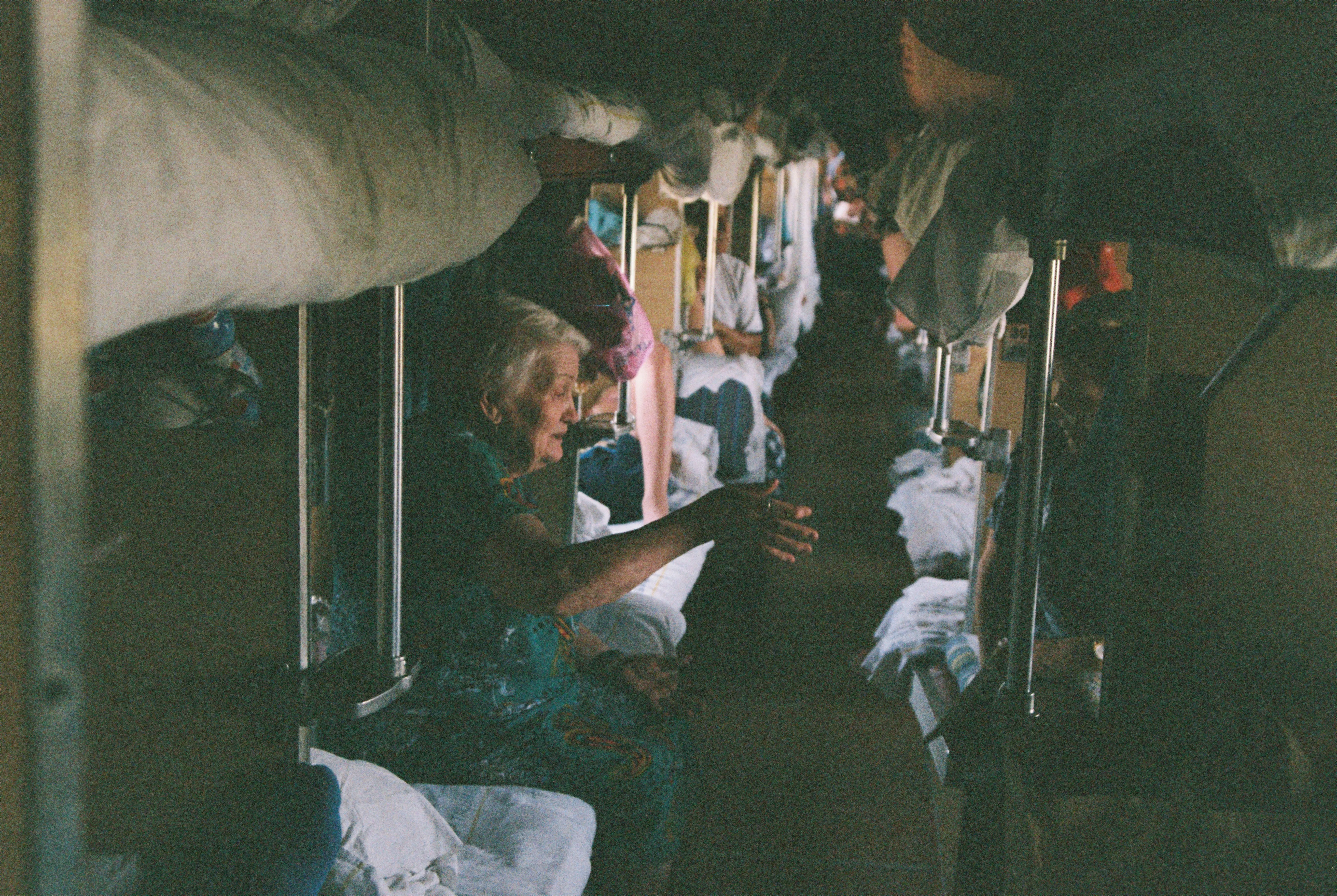 Timeless Journey: Elder Woman in a Bustling Train Car