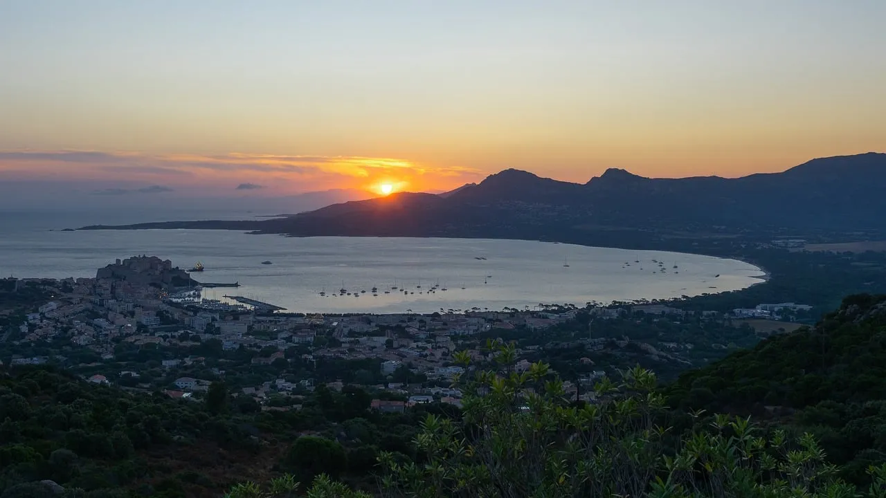 Breathtaking Calvi Sunrise: Orange Sky Over Mediterranean Coast
