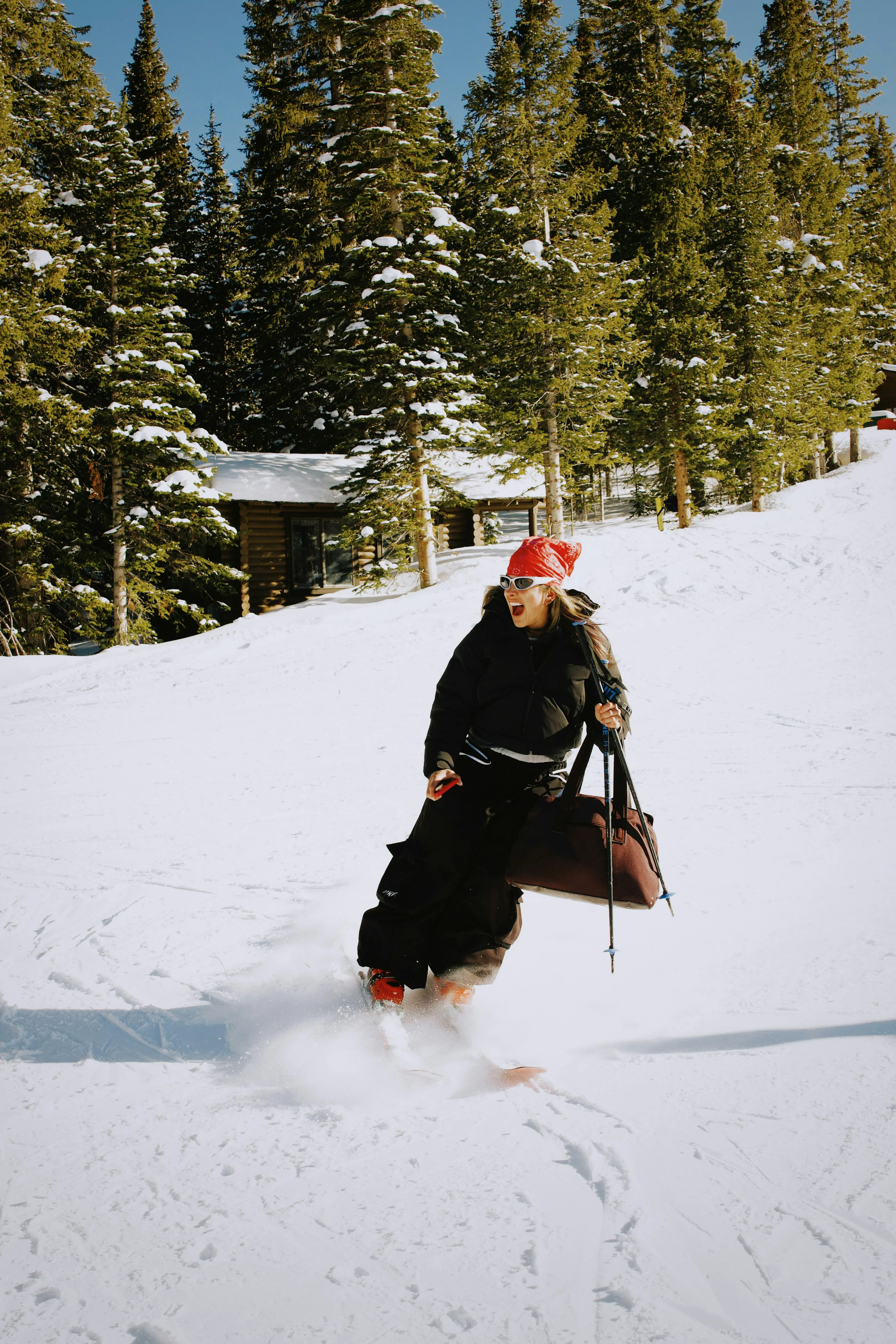 Thrilling Ski Descent: Woman Conquering Snowy Slopes with Bag