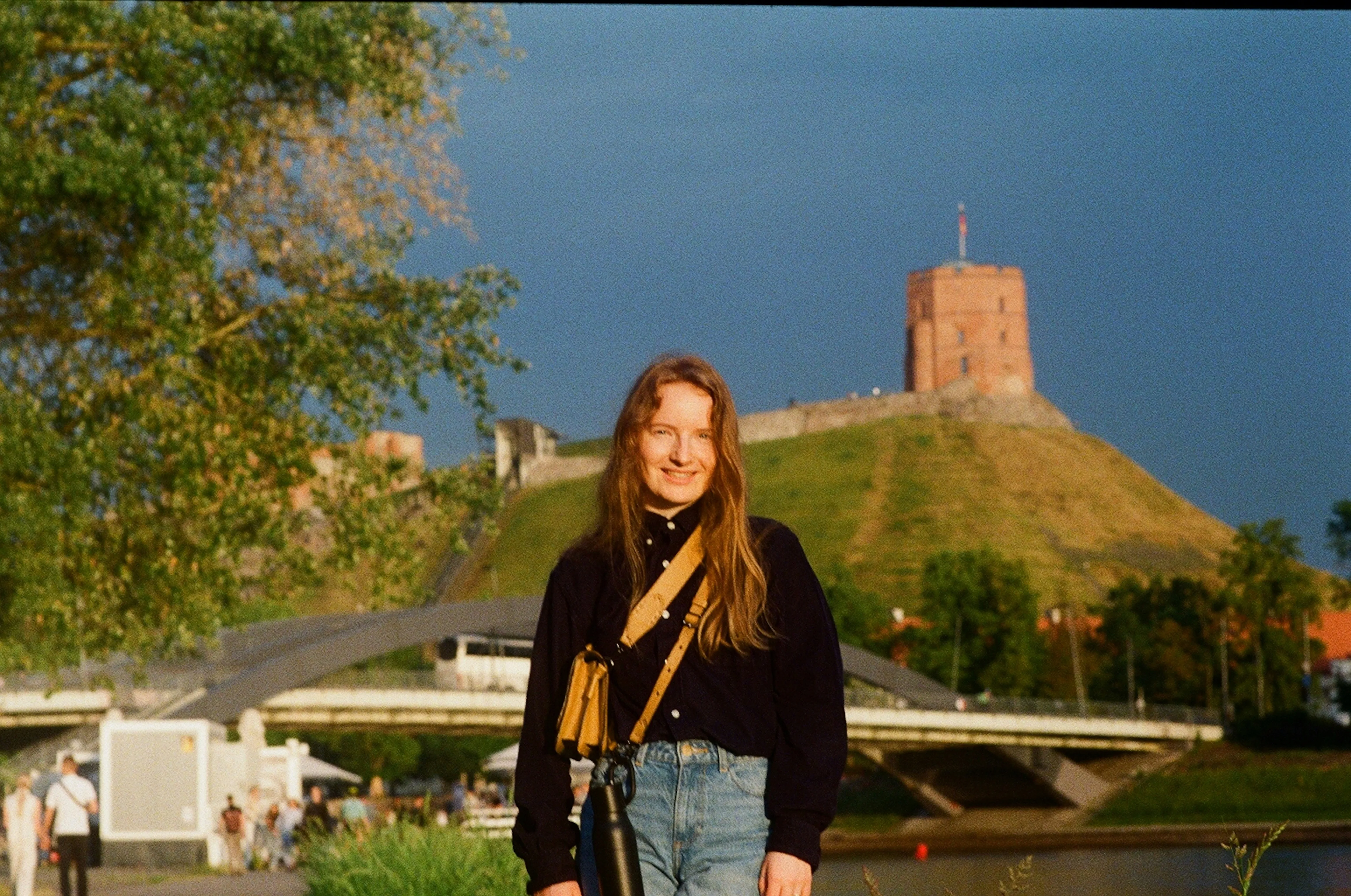 Charming Smile Amidst Historic Grandeur: Woman by Ancient Castle