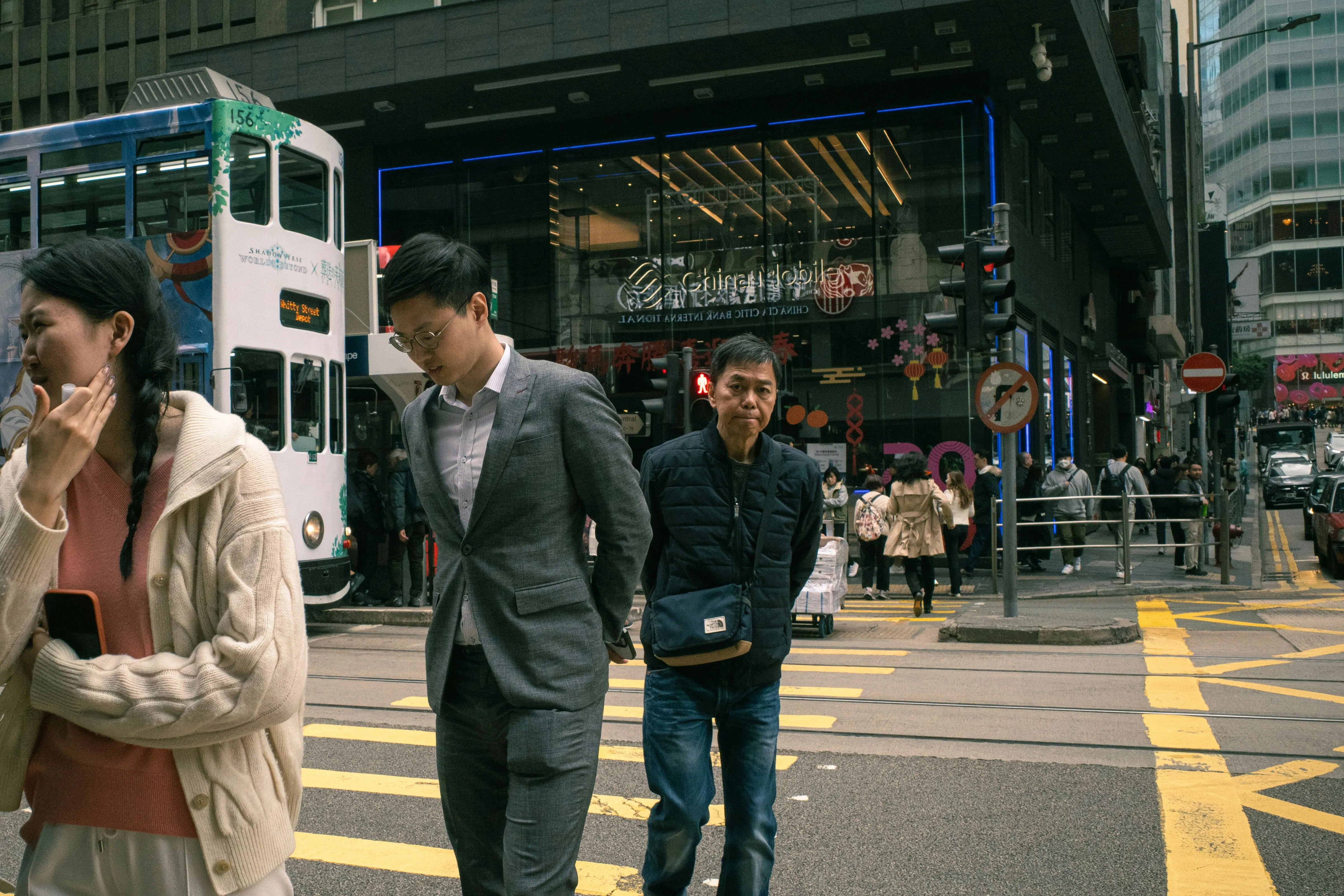 Vibrant City Life: Pedestrians Navigate a Bustling Street Crossing