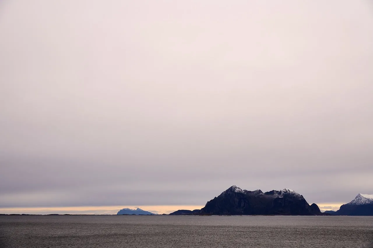 Serene Northern Twilight: Majestic Mountains Meet Calm Sea